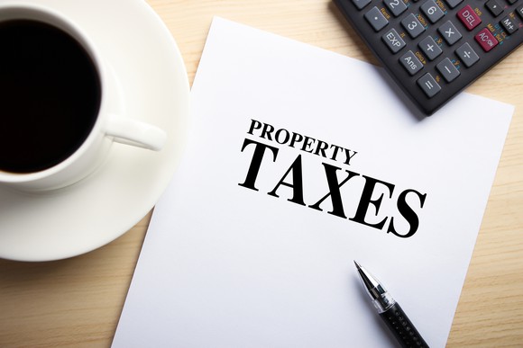 Property tax report with cup of coffee and calculator