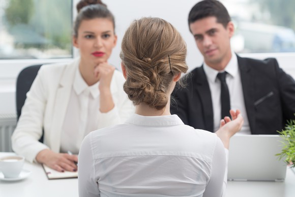 A woman sits at a job interview.