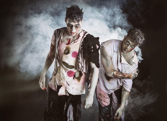 Two zombies give menacing looks.