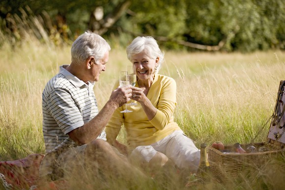 Senior couple toasting outdoors