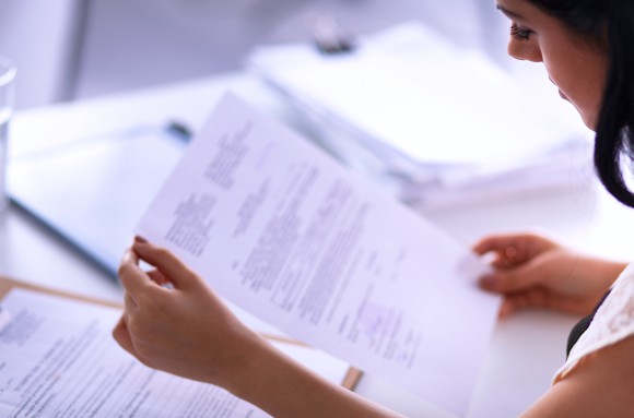 Woman looking at paperwork.