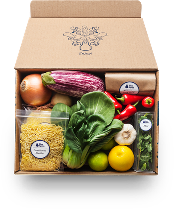 A Blue Apron delivery box containing noodles, vegetables, and fruit.
