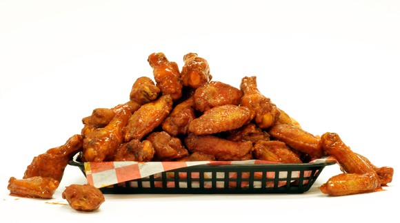 A messy basket of buffalo wings.