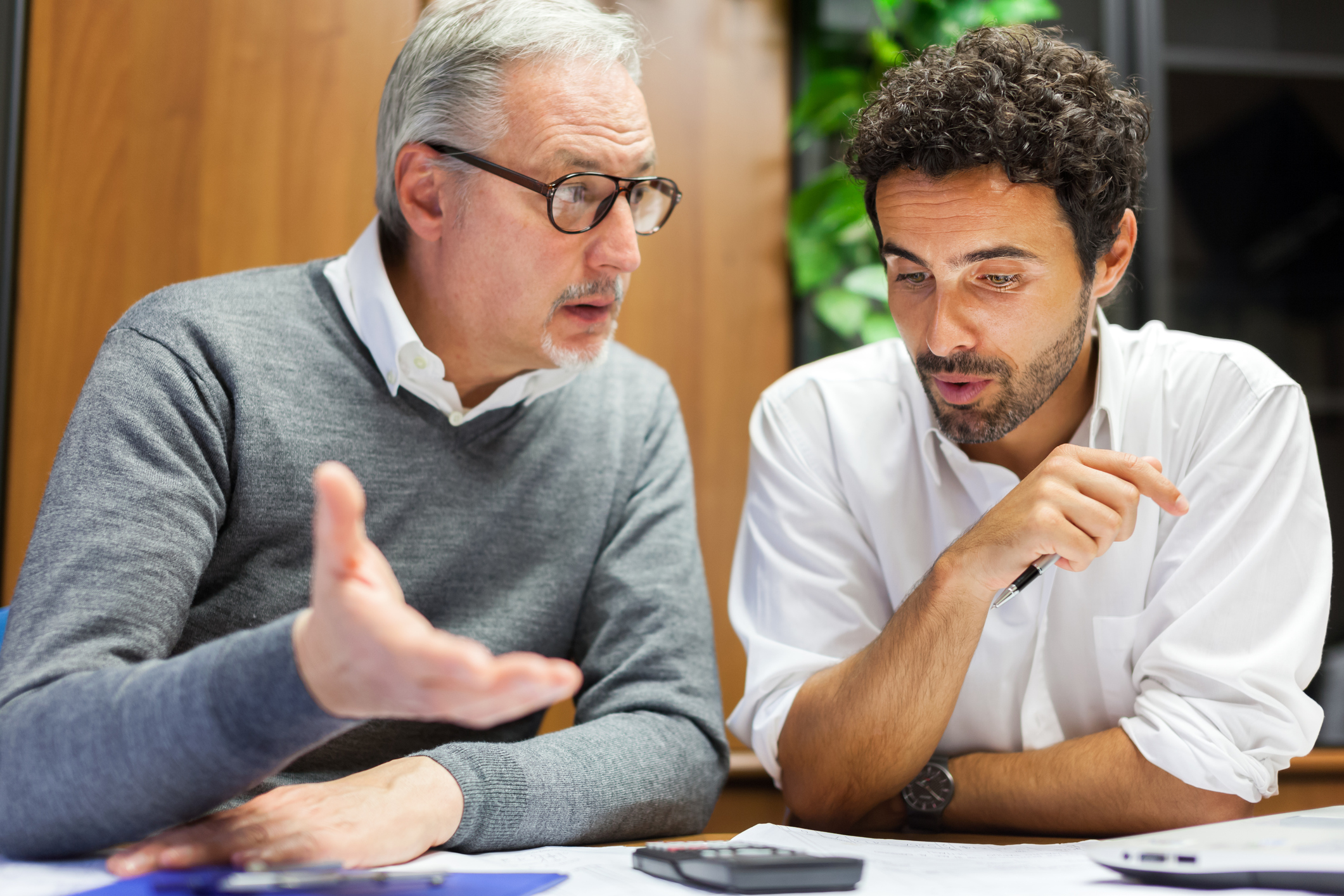 two men talking about finances