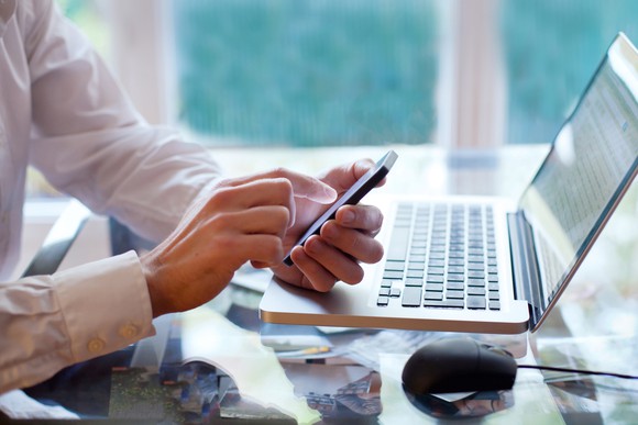 Man checking cell phone at work