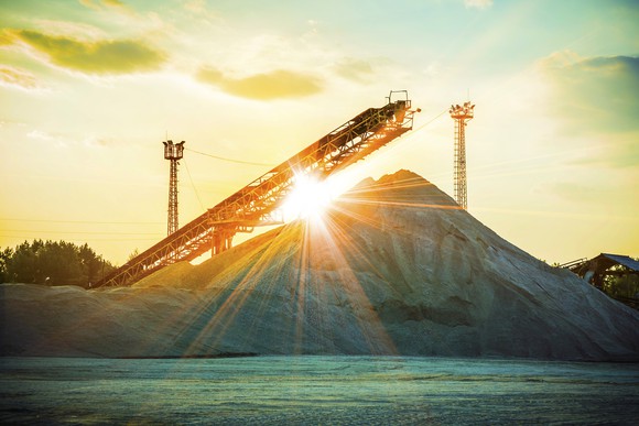 The sun shining over a pile of sand.