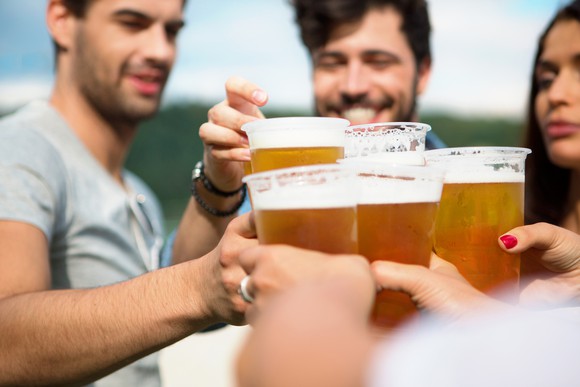 Friends drinking draft beer in summertime.