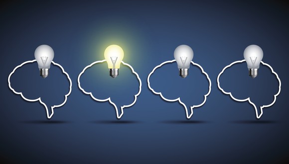 Outline of four human brains with light bulbs on top of each -- one is lit up.