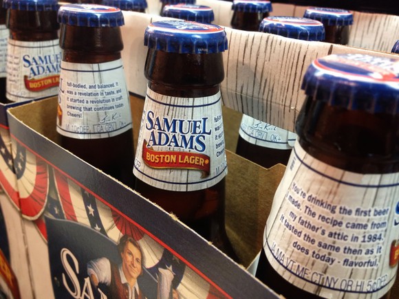 Samuel Adams beer bottles in a six-pack case.