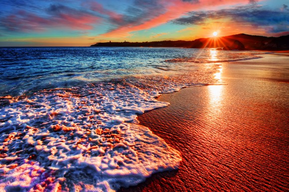 Sun settting over a beach.