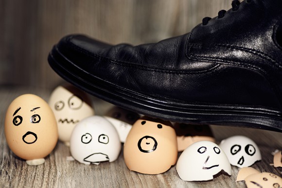 A shoe stepping on eggs