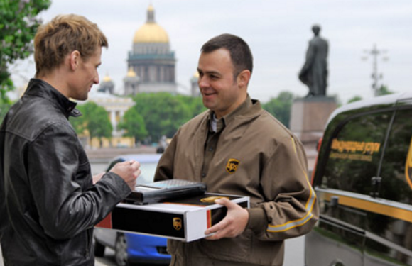 A UPS delivery man delivering a package.