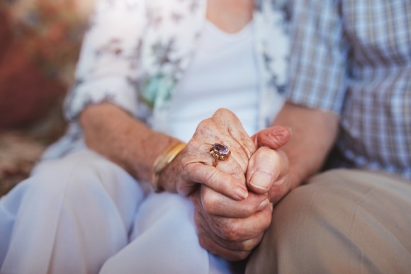 Senior couple holding hands
