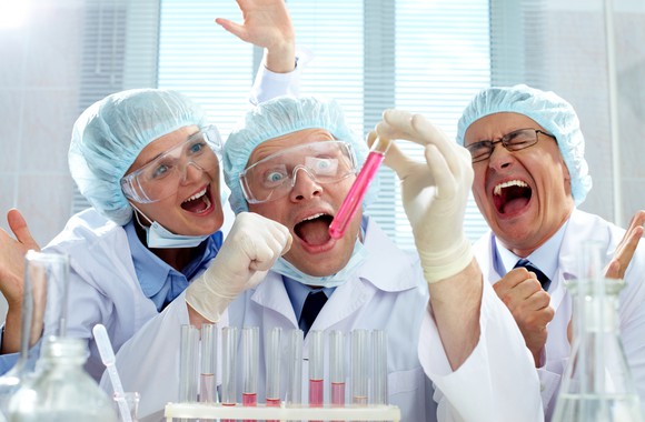 Three extremely emotional scientists being happy about the result of the experiment.