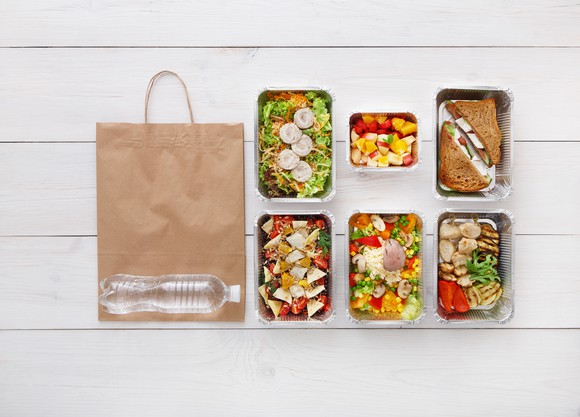 Pre-packaged meals with a bag on the floor.