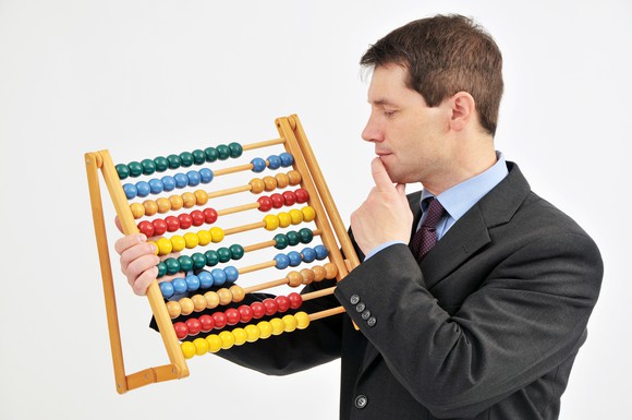 A businessman using an abacus.