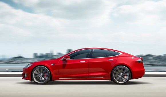 2017 Tesla Model S in red driving near San Francisco Bay.