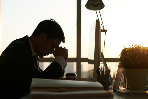 Man stressed out at his desk.