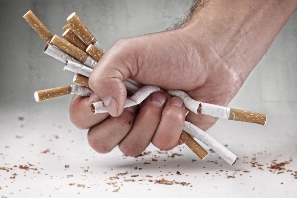 Hand crushing cigarettes