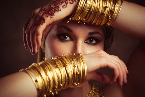 A woman with gold bangles on