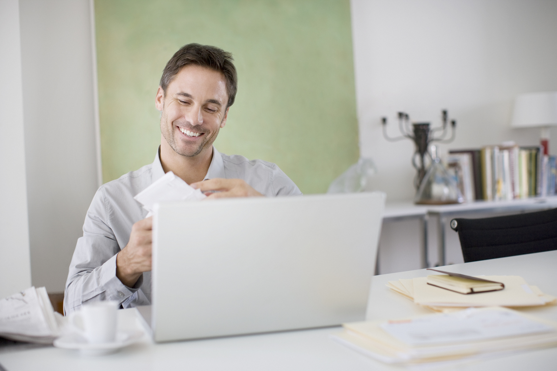 Man opening mail at desk