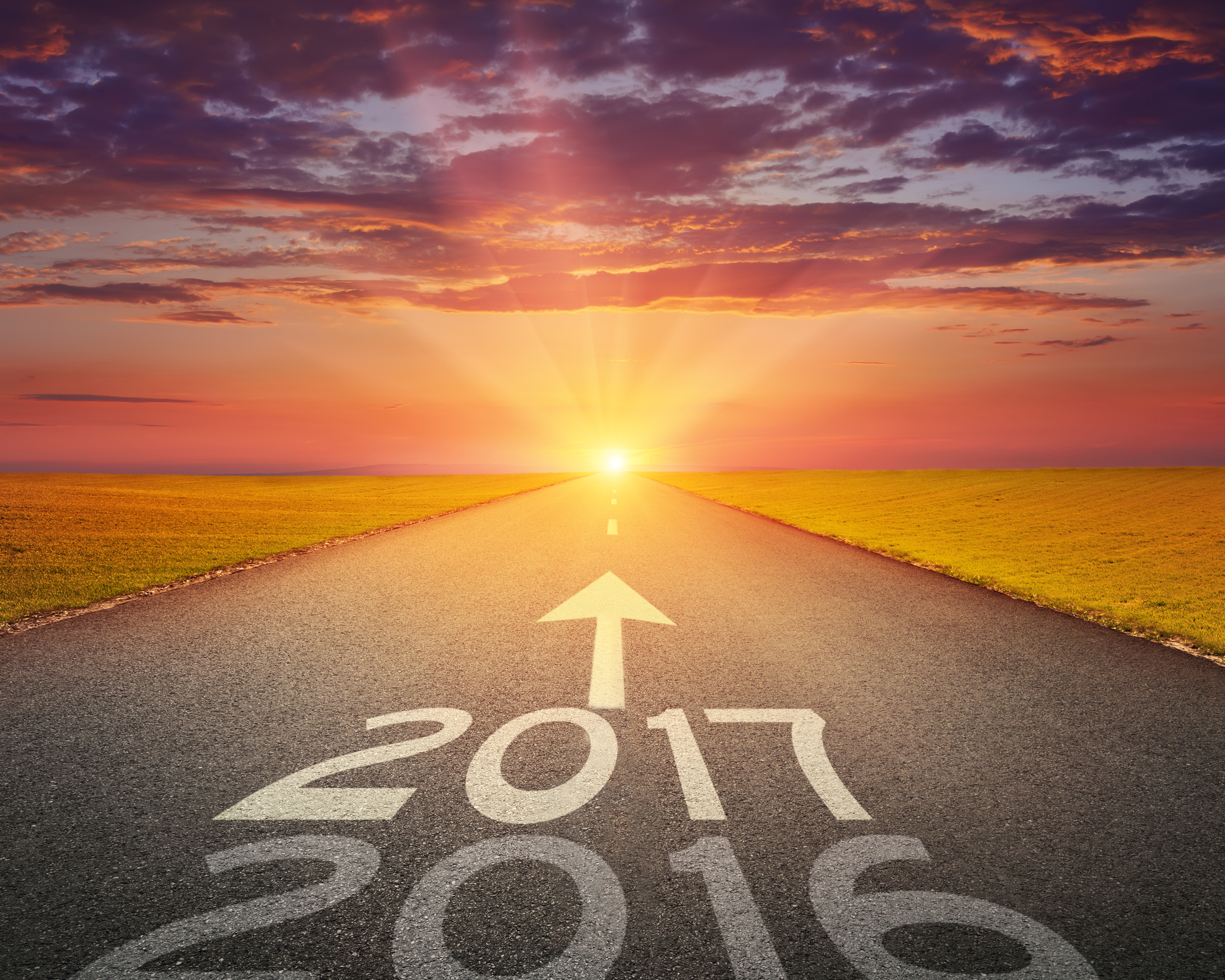 Bright future concept, with years written on road toward sunny sky.