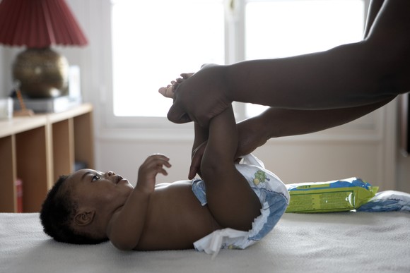 A baby has its diaper changed.