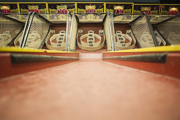 Skee ball game at an arcade.