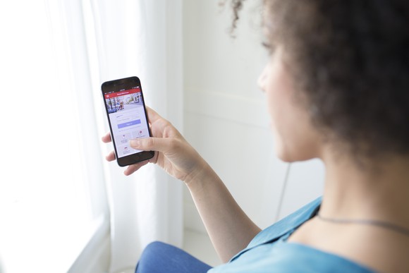 Woman using Bank of America's mobile app.