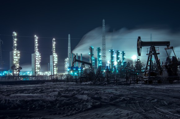 Oil pumps and an industrial site at night.