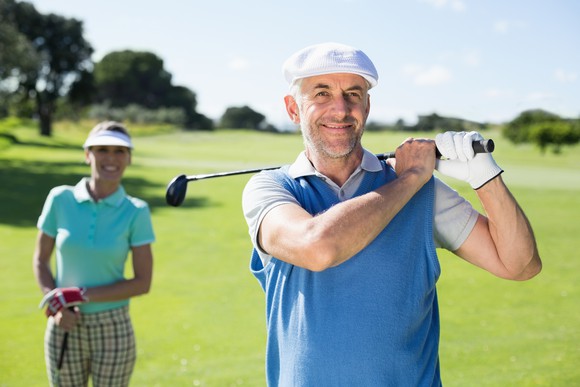 A husband and wife playing golf