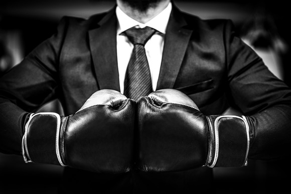 A businessman in boxing gloves.