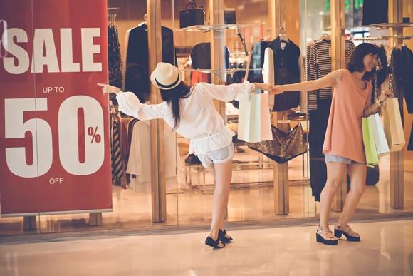 A woman is pulled away from a retail sale
