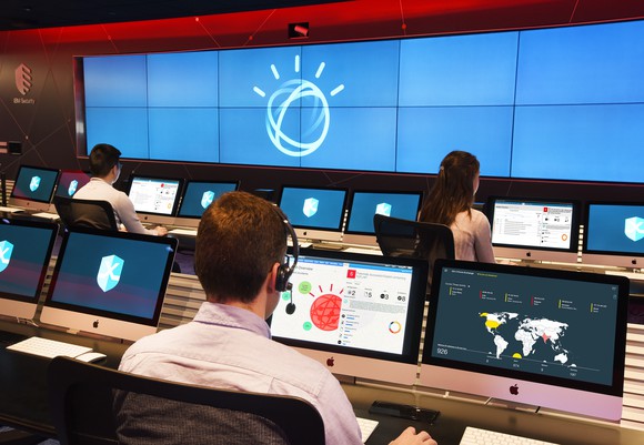Security analysts at IBM's X-Force Command Center using Watson to investigate cybersecurity incidents.