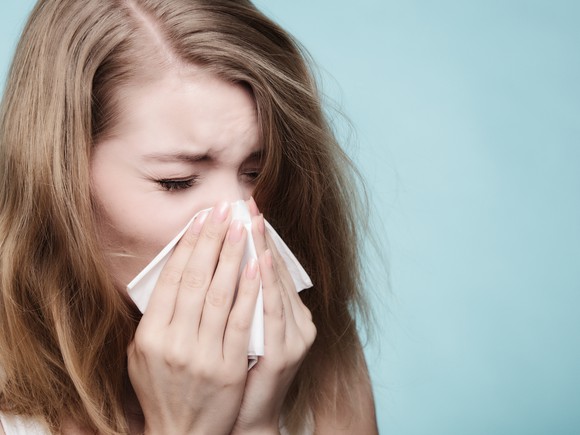 Woman sneezing