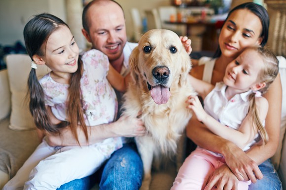 A family portrait, with the family dog at the center.
