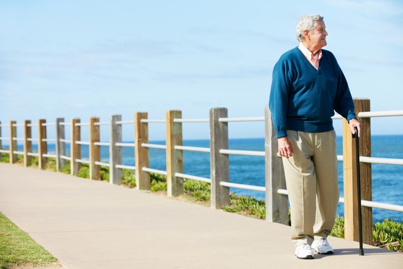 Senior man walking by the water