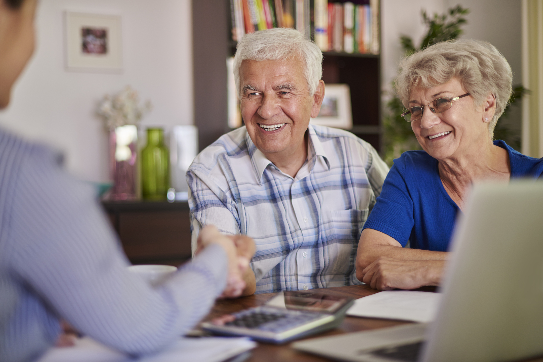 Retired couple talking with another person