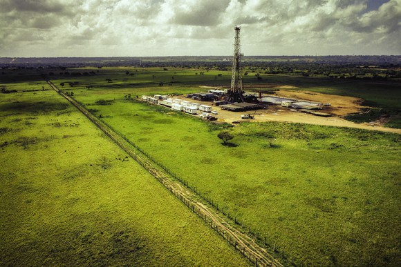 Drilling rig in pasture.
