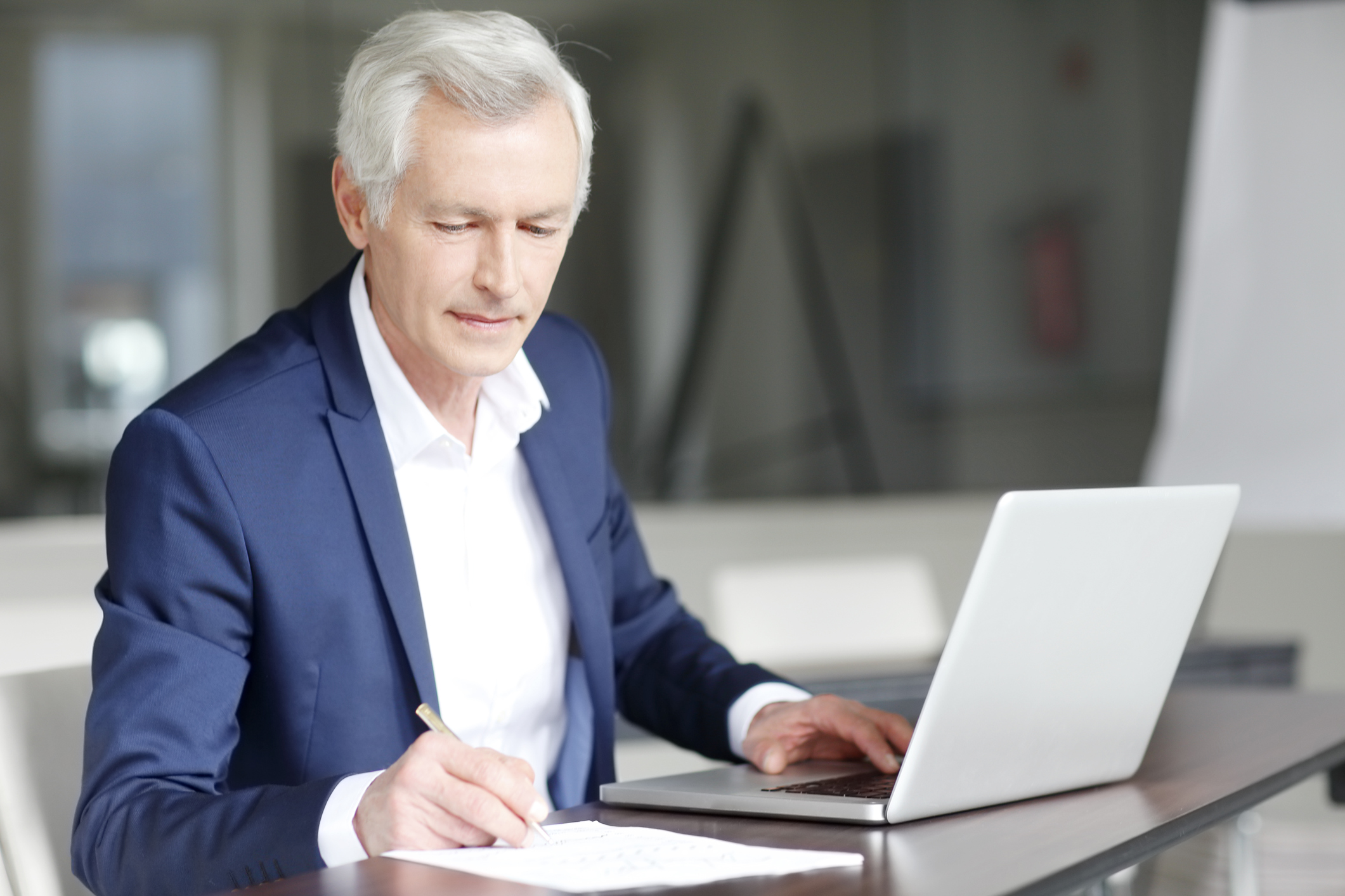 Older businessman working at a computer.