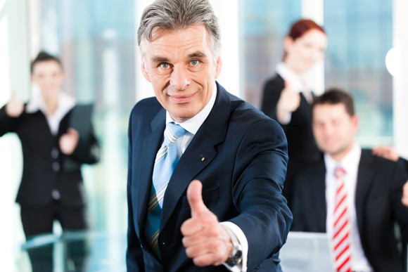business people giving the thumbs up