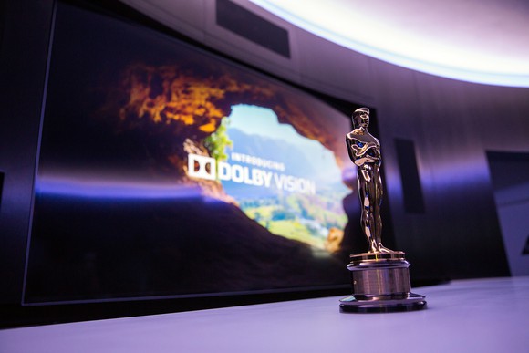Oscar statuette in front of a screen with the text: "Introducing Dolby Vision."