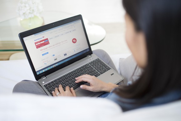 Woman logging into online banking with Bank of America
