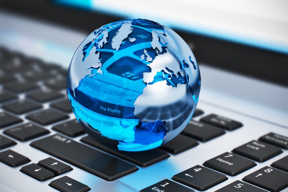 A glass globe on top of a computer keyboard