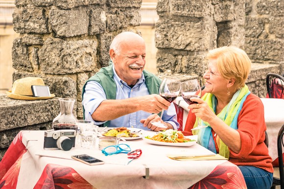 Retired couple dining outdoors
