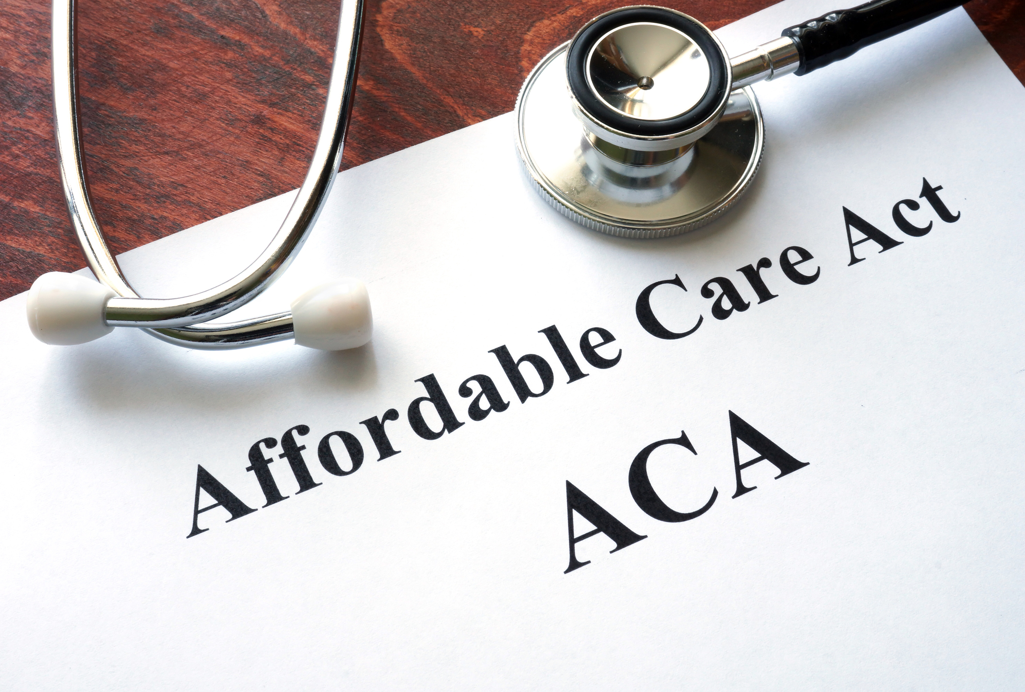 A piece of paper displaying the words "Affordable Care Act" with a stethoscope on top