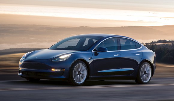 A blue Tesla Model 3 sedan.