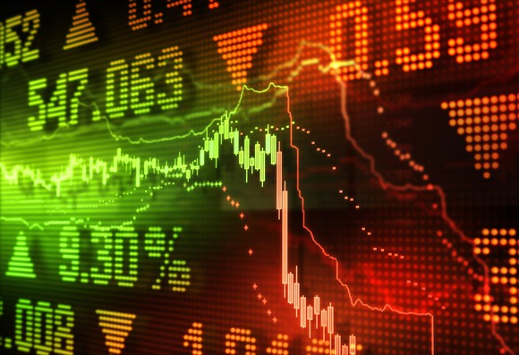 A stock chart plunges on a digital board.