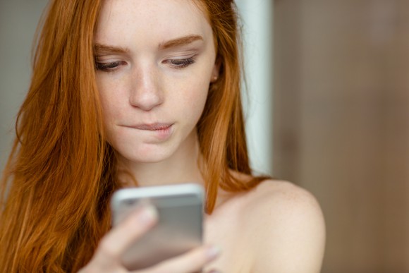 A woman looking at her smartphone