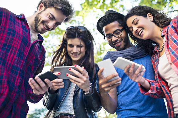 Group of friends on their smartphones